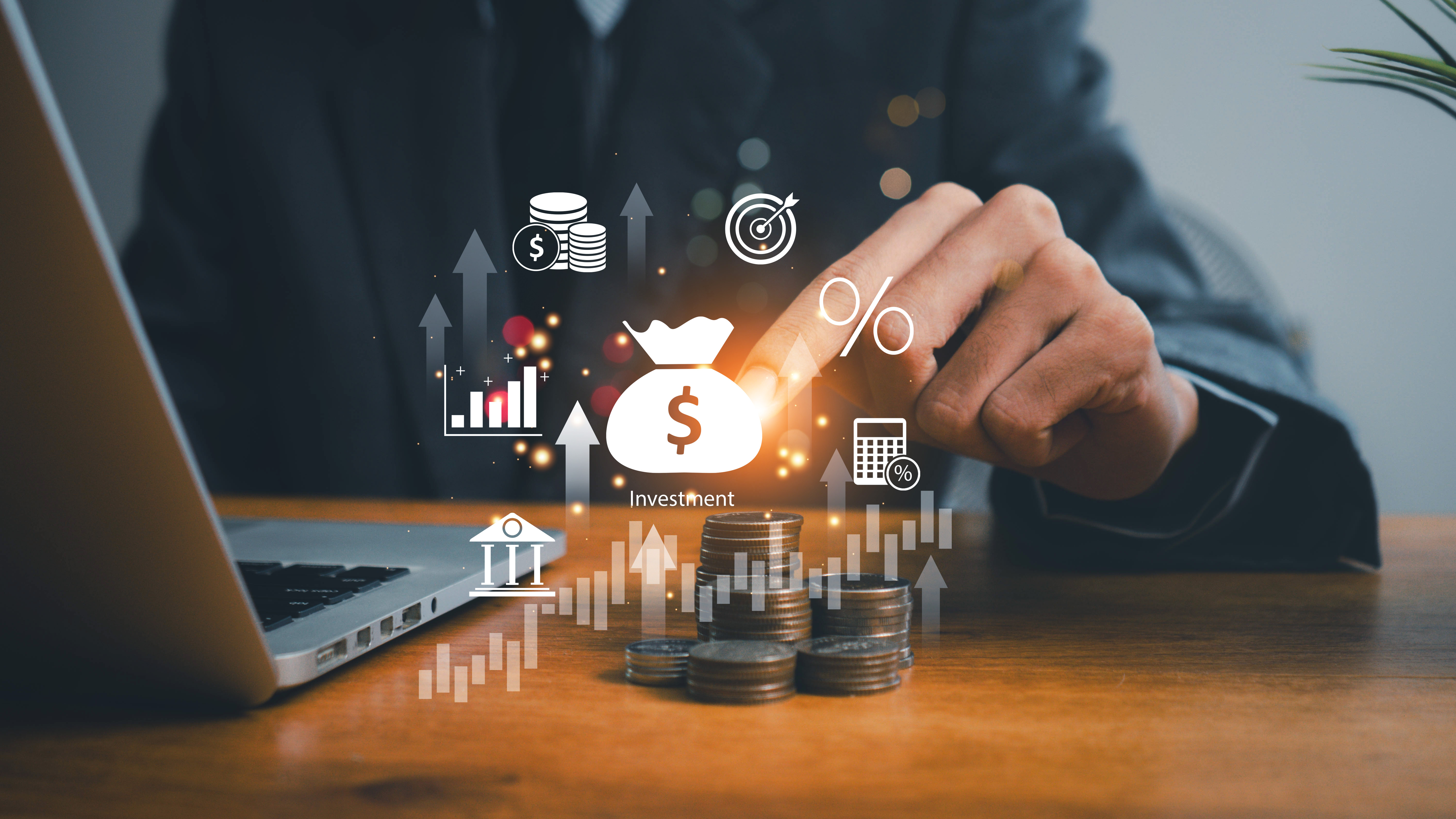 Financial symbols placed against the background of a man counting coins at a computer. This arrangement symbolizes taking care of responsible financial management