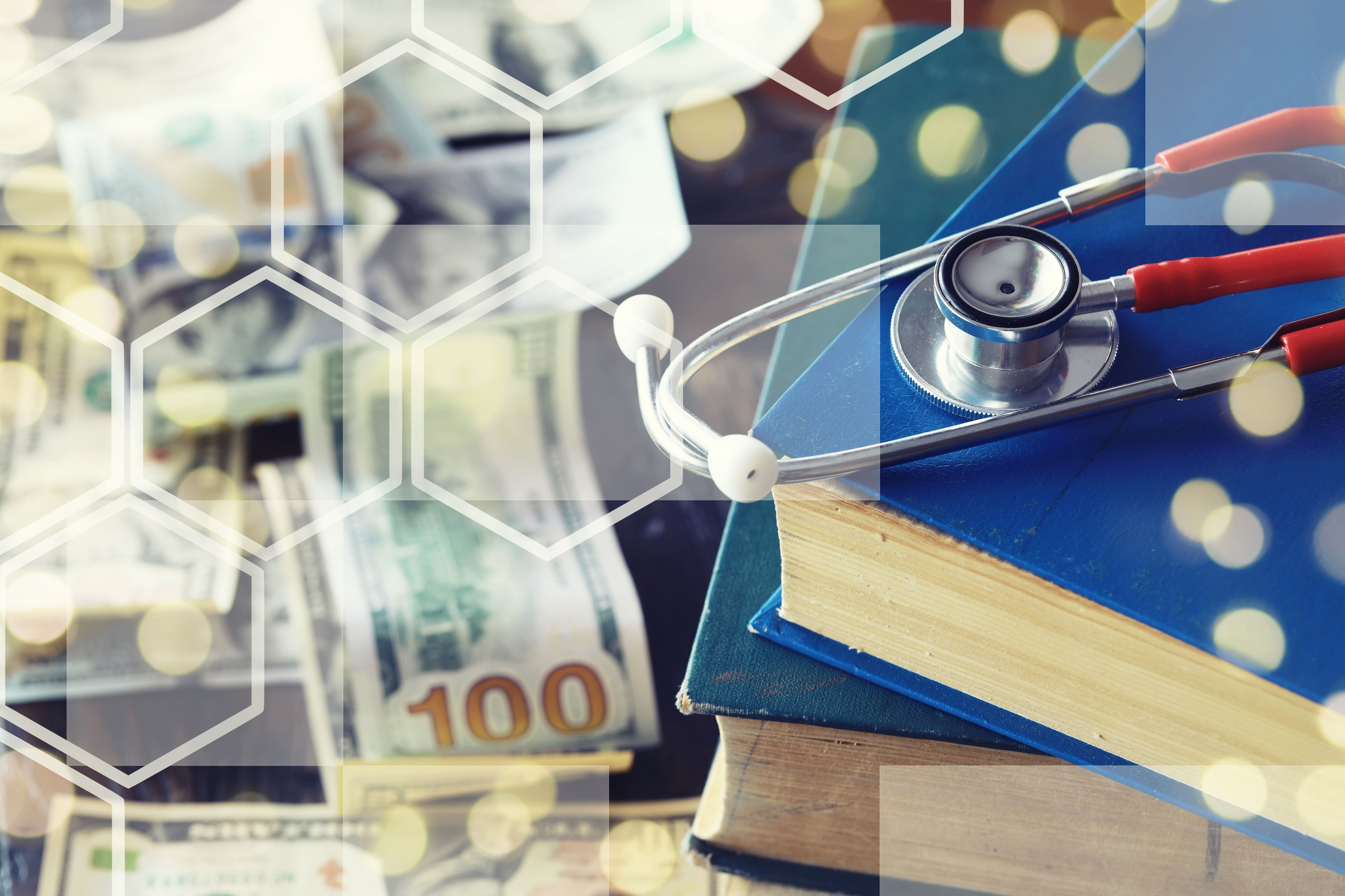 A stethoscope resting on medical books with a blurred background of dollar bills, that symbolizes financial management for medical professionals.