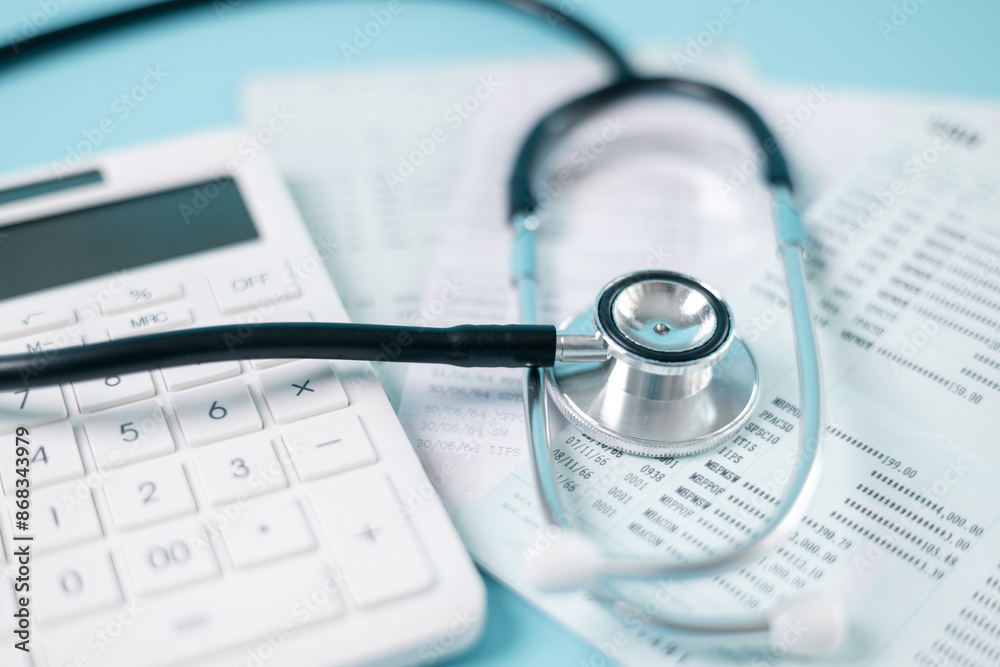 A stethoscope, calculator, and financial documents symbolizing tax planning, budgeting, and financial management for medical professionals